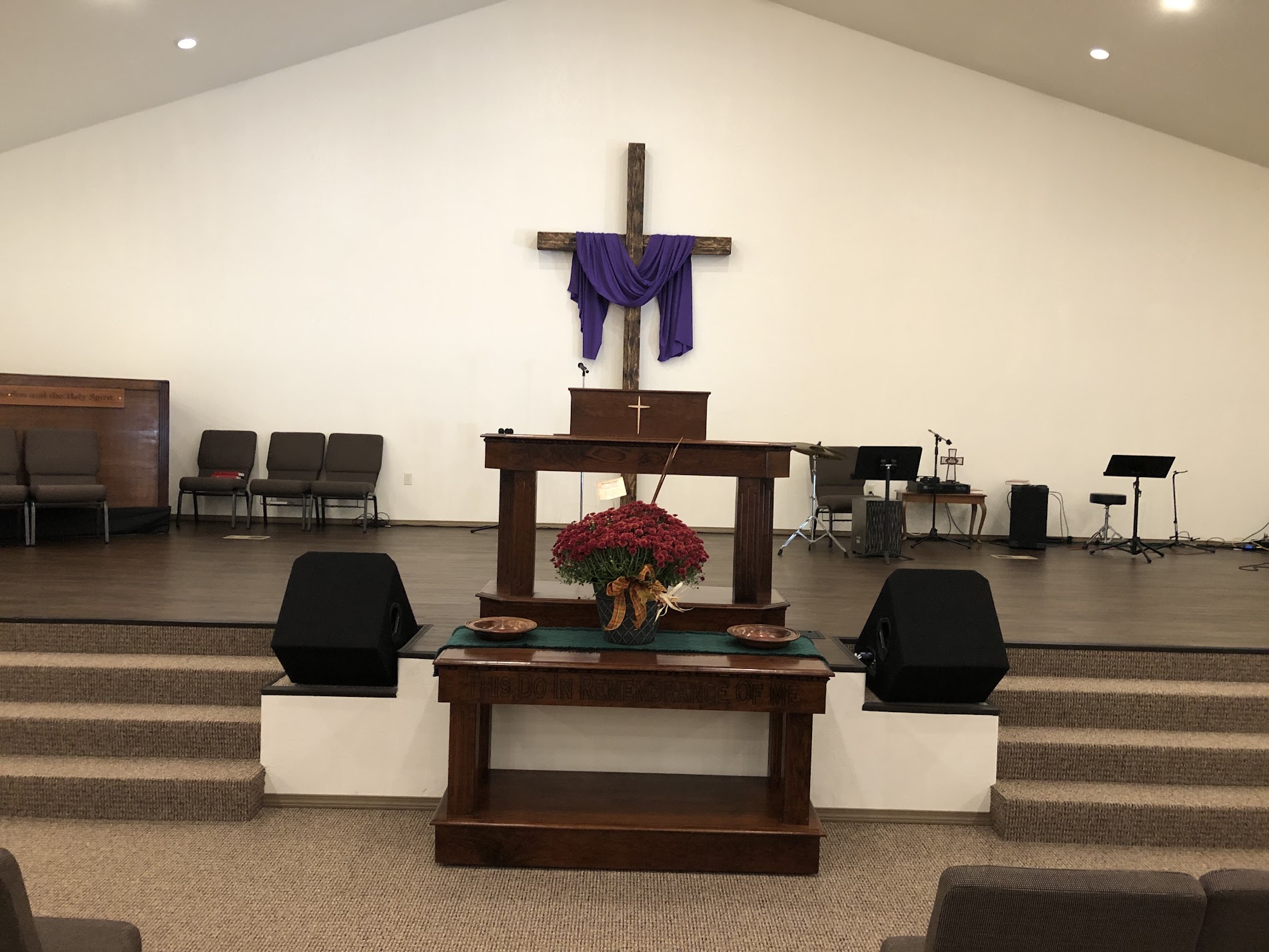 Cross and pulpit inside the sanctuary at Beacon Baptist Church